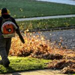 Worker,Blowing,Leaves,In,The,Fall,With,Leaf,Blower
