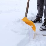 Man,Removing,Snow,From,The,Sidewalk,After,Snowstorm.
