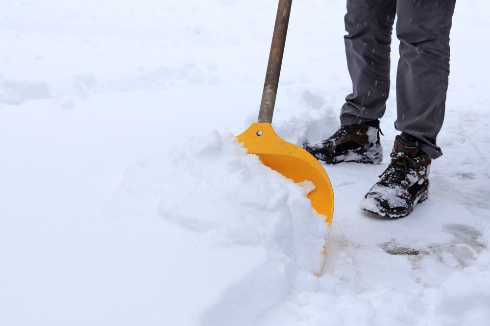 Man,Removing,Snow,From,The,Sidewalk,After,Snowstorm.