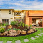 Beautiful,Luxury,Home,Exterior,With,Balcony,And,Green,Grass,On